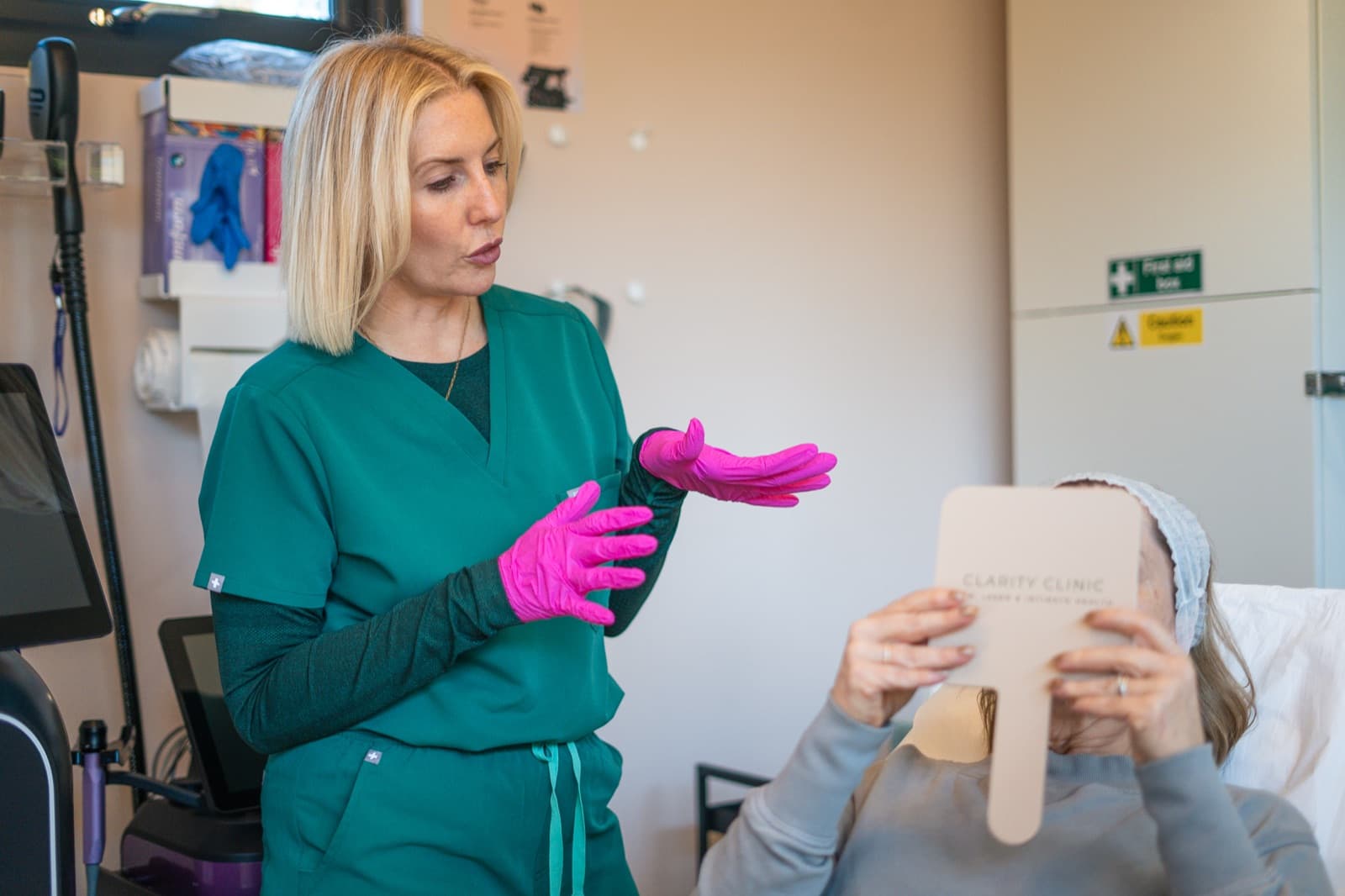 Claire explaining results to a client holding a mirror
